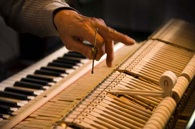 Person tuning a piano