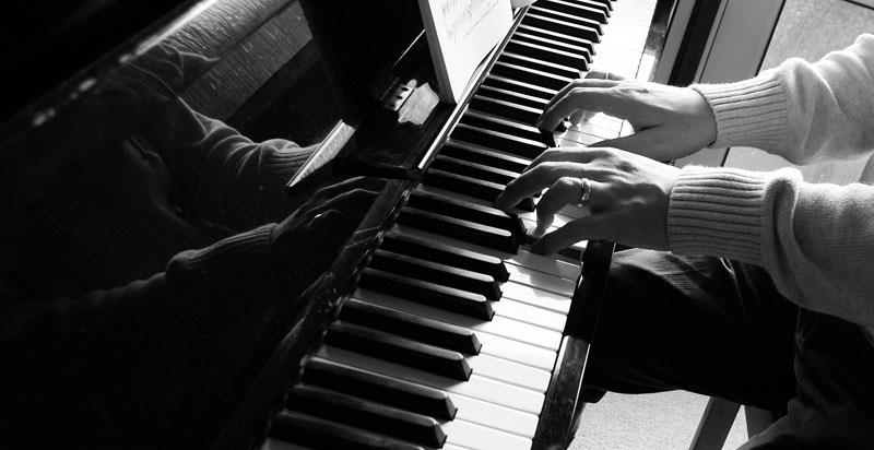 Hands playing piano