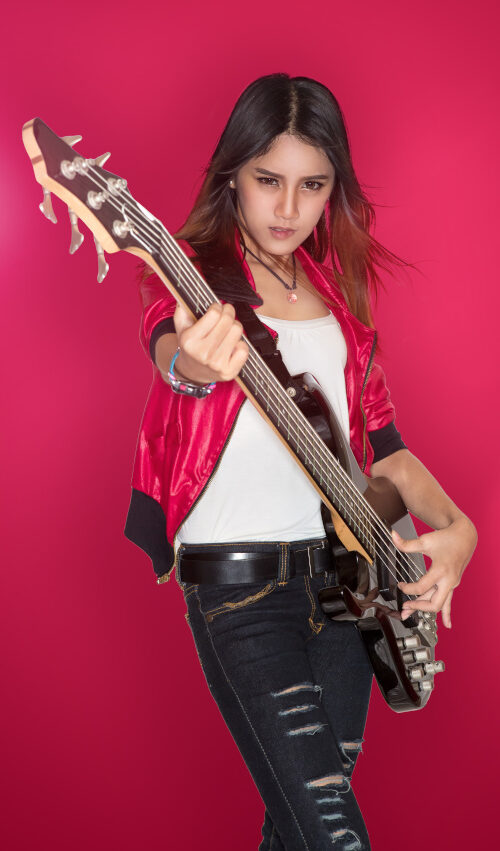 Young person playing bass guitar